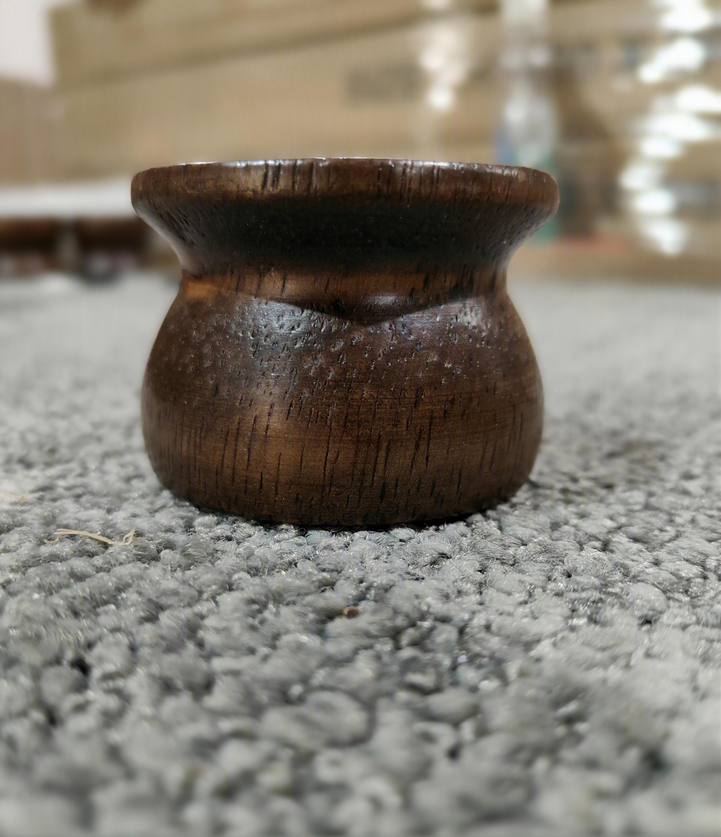 Rounded wooden feet raising cabinet base off the floor — moisture barrier between wood and ground